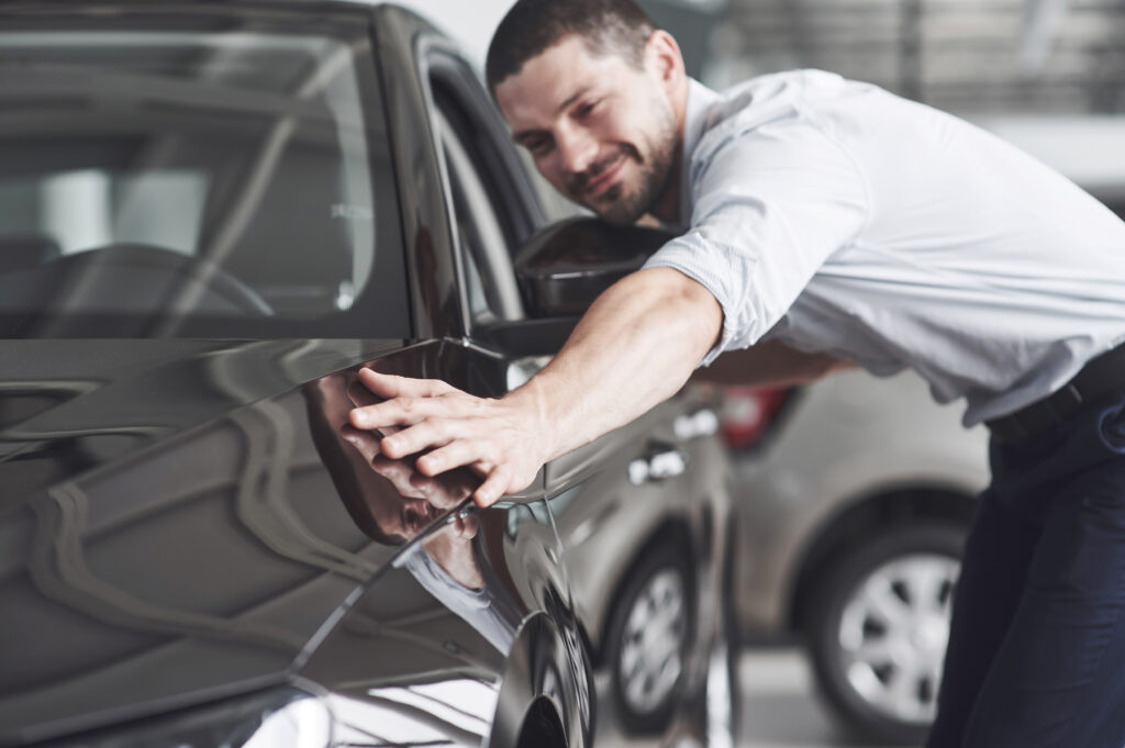 man admiring his car